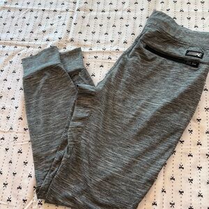 Grey leggings with drawstring, zippered pockets and gathered ankle fit.